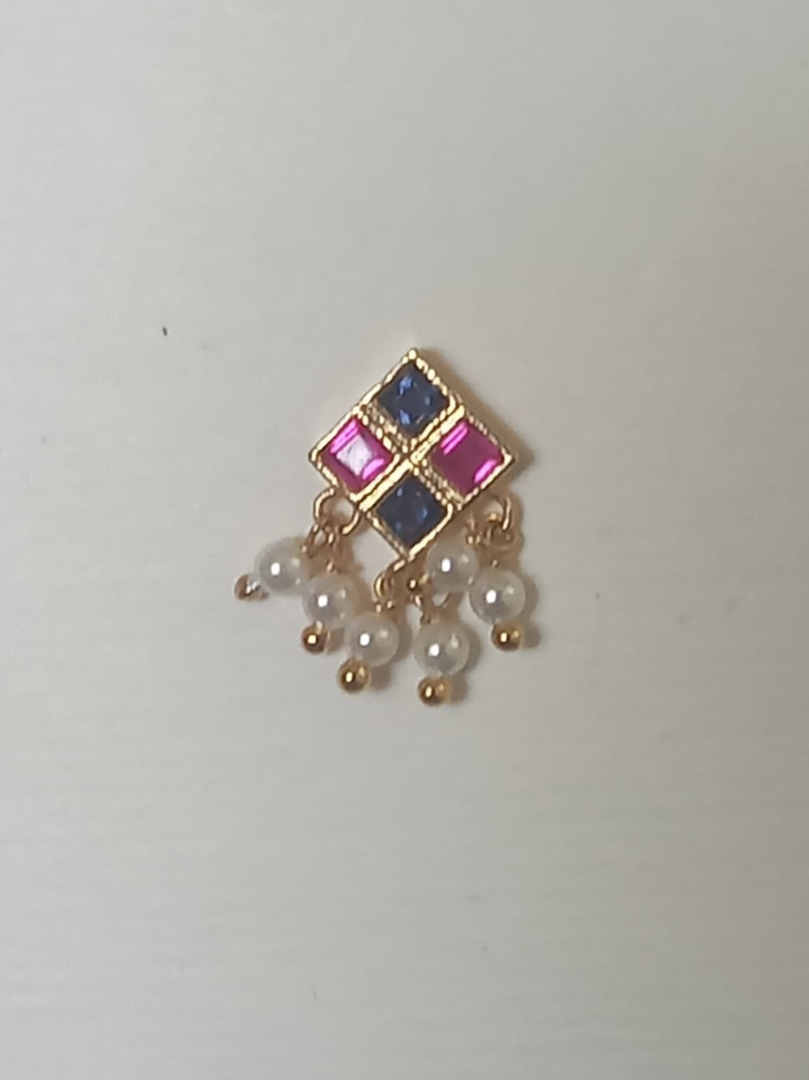 Silver nosepins featuring traditional motifs with a modern design twist, displayed on a neutral background.
