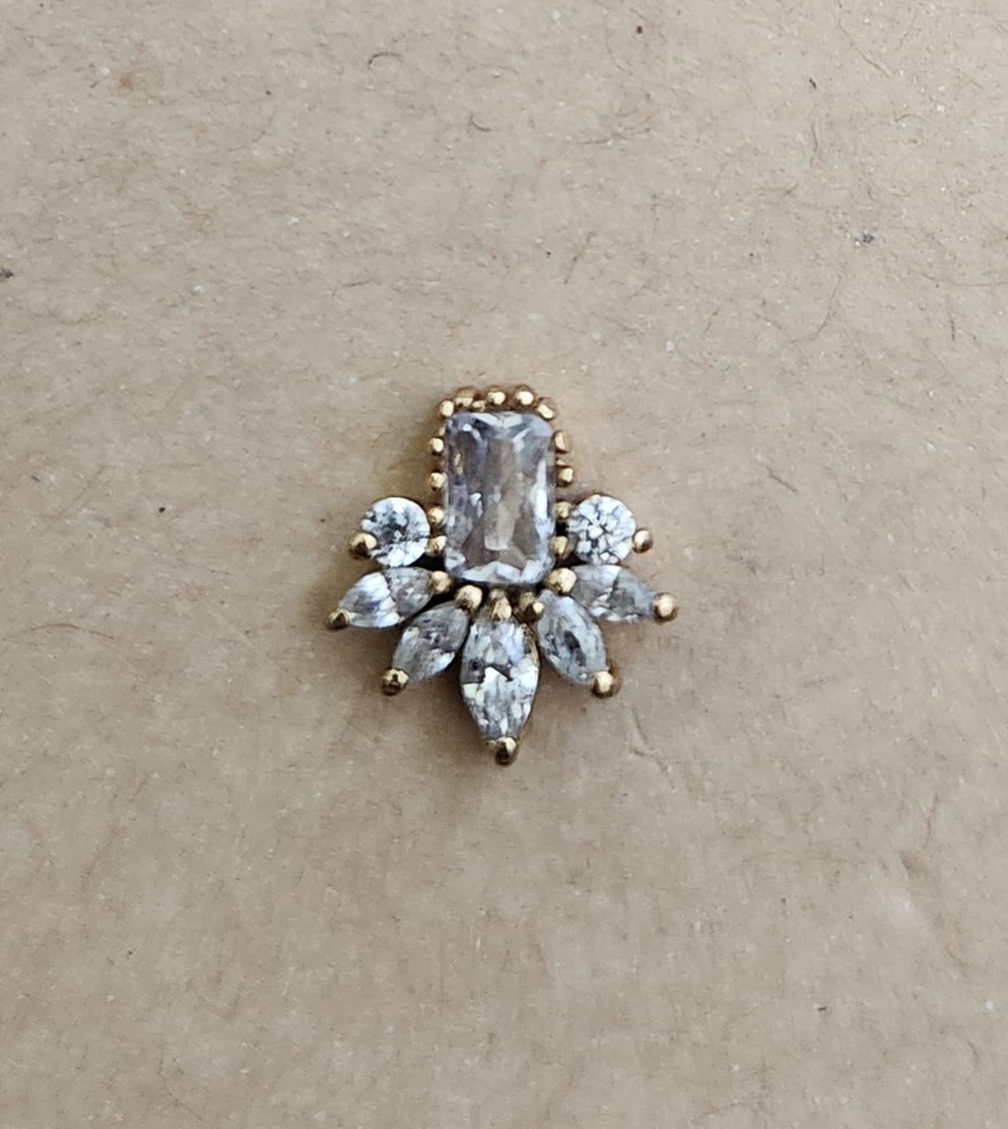 Silver nosepins featuring traditional motifs with a modern design twist, displayed on a neutral background.